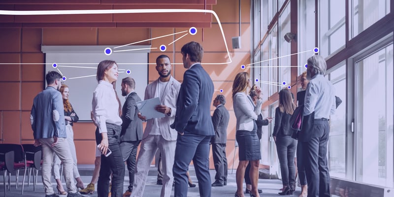 employees in a large commercial office space collaborating 