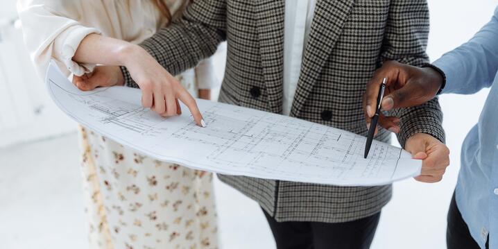 employees collaborating on a floor plan