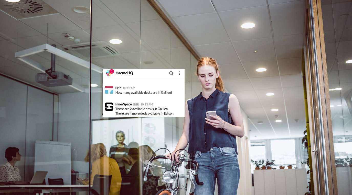 Woman walking into hybrid office finding a desk with the use of indoor location technology