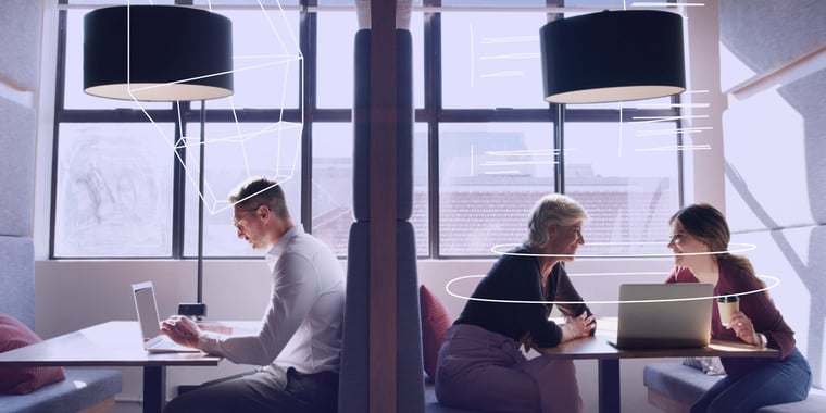 employees working from work booths together